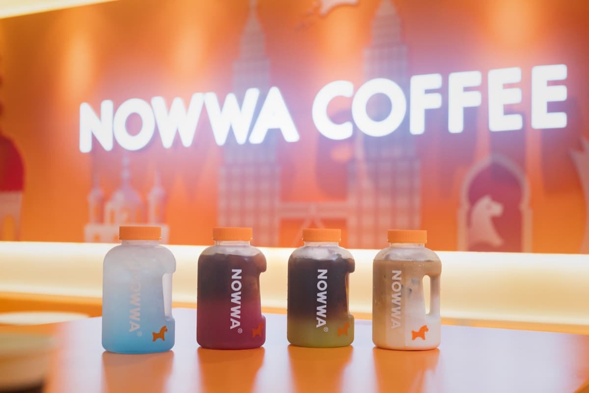 NOWWA bottled coffee on the counter with the brand backdrop